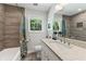 Bright bathroom with a tiled shower/tub, granite countertops, and a window offering natural light at 2574 Warwick Dr, Marietta, GA 30062