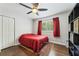 Cozy bedroom with hardwood floors, ceiling fan, closet, and a window with natural light at 2574 Warwick Dr, Marietta, GA 30062
