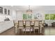 Formal dining room with large windows, a decorative chandelier, and wooden floors at 2574 Warwick Dr, Marietta, GA 30062