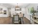 Formal dining room with white cabinets, granite countertops, wooden floors, and stainless appliances at 2574 Warwick Dr, Marietta, GA 30062
