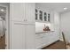 Pantry and serving area with white cabinets, granite countertops, and glass-front display cabinets at 2574 Warwick Dr, Marietta, GA 30062