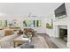 Elegant living room with a fireplace, hardwood floors, and ample natural light, creating a cozy atmosphere at 2574 Warwick Dr, Marietta, GA 30062