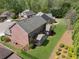 Aerial view of the backyard featuring a well-manicured lawn, trees, and a black metal fence at 4650 Brighton View Trl, Cumming, GA 30040