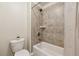 Neat bathroom with a toilet, a tub shower and neutral wall and tile colors at 4650 Brighton View Trl, Cumming, GA 30040