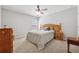 Comfortable bedroom with a ceiling fan, neutral carpet, and plenty of natural light at 4650 Brighton View Trl, Cumming, GA 30040