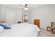 Neutral bedroom with a ceiling fan, a bright window, and standard furnishings at 4650 Brighton View Trl, Cumming, GA 30040