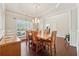 Elegant dining room with hardwood floors, tray ceiling, chandelier, and traditional furniture, perfect for Gathering gatherings at 4650 Brighton View Trl, Cumming, GA 30040