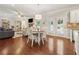 Open concept dining room with modern chandelier, plantation shutters, and access to the outdoor space at 4650 Brighton View Trl, Cumming, GA 30040