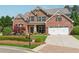 Beautiful brick home with manicured lawn, two-car garage, and inviting front porch perfect for relaxing and enjoying the neighborhood at 4650 Brighton View Trl, Cumming, GA 30040
