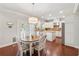 Eat-in kitchen with stainless steel appliances, granite countertops, white cabinets, and central island offers great dining space at 4650 Brighton View Trl, Cumming, GA 30040