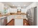 Modern kitchen featuring stainless appliances, granite countertops, ample cabinetry, and a center island at 4650 Brighton View Trl, Cumming, GA 30040