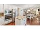 Well appointed kitchen with stainless appliances and granite countertops overlooking the dining area at 4650 Brighton View Trl, Cumming, GA 30040
