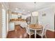 Bright eat-in kitchen featuring white cabinetry, stainless steel appliances, granite counters, and modern light fixture at 4650 Brighton View Trl, Cumming, GA 30040