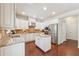 Well-lit kitchen with white cabinets, granite counters, stainless appliances, and a functional center island at 4650 Brighton View Trl, Cumming, GA 30040