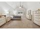 Spacious bedroom featuring neutral carpet, vaulted ceiling, ceiling fan, and ample natural light at 4650 Brighton View Trl, Cumming, GA 30040