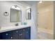 Modern bathroom featuring a stylish vanity with mirror and a tiled shower/tub combo at 4992 Meadow Ln, Marietta, GA 30068