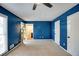 Spacious bedroom featuring blue walls, carpeted floors, and natural light at 4992 Meadow Ln, Marietta, GA 30068