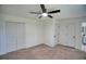 Neutral bedroom with a ceiling fan and large closet doors for ample storage at 4992 Meadow Ln, Marietta, GA 30068