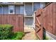 Charming front entrance with a wooden gate, stone pathway, and the house number on display at 4992 Meadow Ln, Marietta, GA 30068