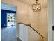 Upstairs hallway with carpeted stairs, modern lighting, and a view into bedroom at 4992 Meadow Ln, Marietta, GA 30068