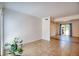 Sunlit living area featuring tiled flooring, plants and a sliding glass door at 4992 Meadow Ln, Marietta, GA 30068