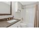 Bathroom with a vanity, granite countertop, framed mirror, and a shower-tub combo with shower curtain at 3235 Roswell Ne Rd # 721, Atlanta, GA 30305