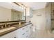 Bathroom with double sinks, white cabinets, and a glass door shower at 3235 Roswell Ne Rd # 721, Atlanta, GA 30305