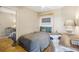 Well-lit bedroom featuring a murphy bed, desk, ceiling fan and hardwood floors, maximizing space and functionality at 3235 Roswell Ne Rd # 721, Atlanta, GA 30305