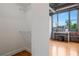 Bedroom with large window, exposed brick wall, hardwood floors, and adjacent closet at 3235 Roswell Ne Rd # 721, Atlanta, GA 30305