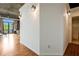 Hallway with hardwood floors and lighting, with an open doorway to the living area and access to a bathroom at 3235 Roswell Ne Rd # 721, Atlanta, GA 30305