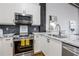 Bright kitchen features stainless steel appliances, granite countertops, and a stylish backsplash at 3235 Roswell Ne Rd # 721, Atlanta, GA 30305