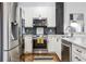 Close up view of a modern kitchen with stainless steel appliances and granite countertops at 3235 Roswell Ne Rd # 721, Atlanta, GA 30305