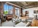 Bright living room features exposed brick, concrete ceilings, stylish furniture, and large windows at 3235 Roswell Ne Rd # 721, Atlanta, GA 30305