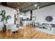 Open floorplan living area with hardwood floors, exposed ceiling, and modern lighting fixtures at 3235 Roswell Ne Rd # 721, Atlanta, GA 30305
