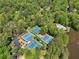 Aerial view showcases tennis courts, a pool and a parking lot surrounded by lush trees at 4553 Pond Ln, Marietta, GA 30062