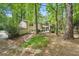 Backyard view of house, with a deck, mature trees, and a natural landscape at 4553 Pond Ln, Marietta, GA 30062