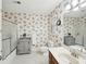 Bathroom boasts floral wallpaper, white tile floor, and a glass-enclosed shower at 4553 Pond Ln, Marietta, GA 30062