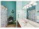 Nautical-themed bathroom with anchor decor, white vanity, and shower with beach-themed curtain at 4553 Pond Ln, Marietta, GA 30062