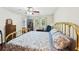 Bright bedroom features a brass bed, wooden floors, and a window view to the outside at 4553 Pond Ln, Marietta, GA 30062