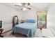 Bedroom featuring blue bedding, a ceiling fan, and natural light streaming through the window at 4553 Pond Ln, Marietta, GA 30062