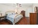 Bedroom features a brass bed, hardwood floors, and traditional wooden furniture at 4553 Pond Ln, Marietta, GA 30062