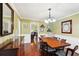Elegant dining room boasting wood floors, wainscoting, and a stylish chandelier at 4553 Pond Ln, Marietta, GA 30062