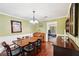A dining room with wood floors, a chandelier, and lots of natural light at 4553 Pond Ln, Marietta, GA 30062