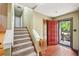 Bright entryway with hardwood floors, stairs to the second floor and convenient coat closet at 4553 Pond Ln, Marietta, GA 30062