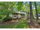 Exterior view of home featuring a wooden porch, bench, and natural, wooded surroundings at 4553 Pond Ln, Marietta, GA 30062