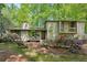 Inviting front exterior featuring a quaint porch, lush landscaping, and natural setting at 4553 Pond Ln, Marietta, GA 30062