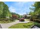 Beautiful home featuring a circular driveway and meticulous landscaping, enhancing its curb appeal and charm at 4553 Pond Ln, Marietta, GA 30062