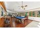 Bright game room with a pool table, wood floors, and walls of windows at 4553 Pond Ln, Marietta, GA 30062