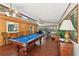 A game room with a pool table, wood floors, and a wood paneled wall at 4553 Pond Ln, Marietta, GA 30062