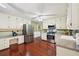 Spacious kitchen featuring stainless appliances, wood floors, a built-in desk, and white cabinetry at 4553 Pond Ln, Marietta, GA 30062